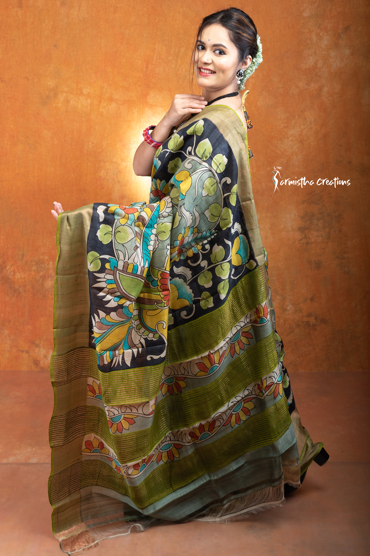 This is a Silk Mark certified zari tussar saree with hand painted kalamkari in multicolour on a pistachio green base.