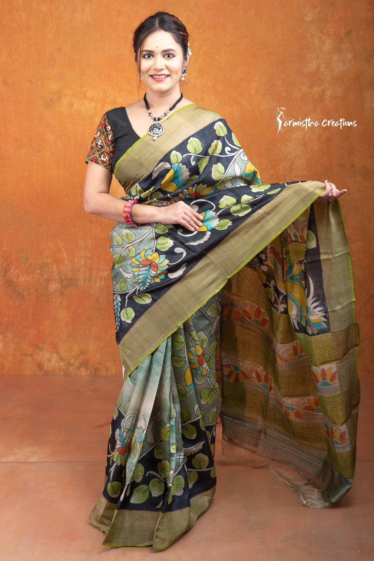 This is a Silk Mark certified zari tussar saree with hand painted kalamkari in multicolour on a pistachio green base.
