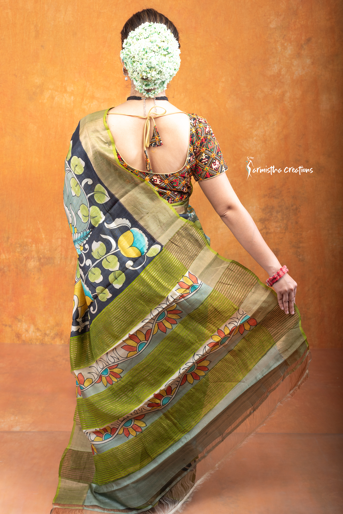 This is a Silk Mark certified zari tussar saree with hand painted kalamkari in multicolour on a pistachio green base.