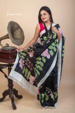 A bold yet graceful statement. Floral Symphony is a hand-painted Bishnupuri silk saree in black, brought to life with vibrant blooms and Bengal artistry.